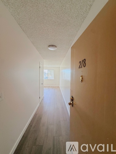 A hallway with a door numbered 218 and Avail logo.