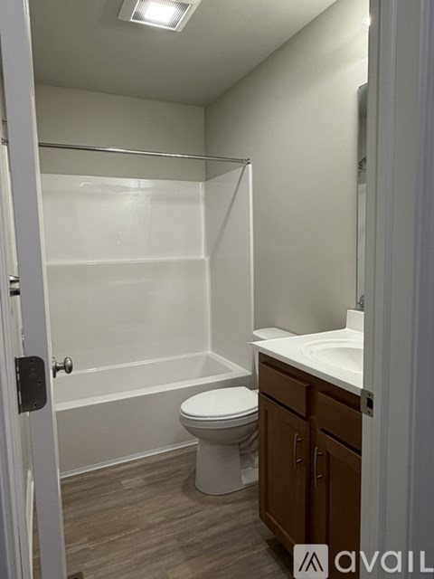 A bathroom with a toilet, sink, and bathtub.
