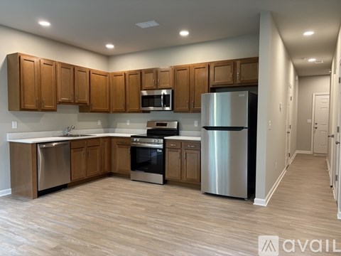 A kitchen with wooden cabinets and stainless steel appliances.