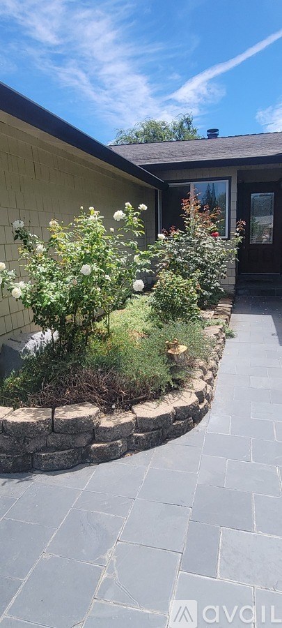 A house with a stone walkway in front.