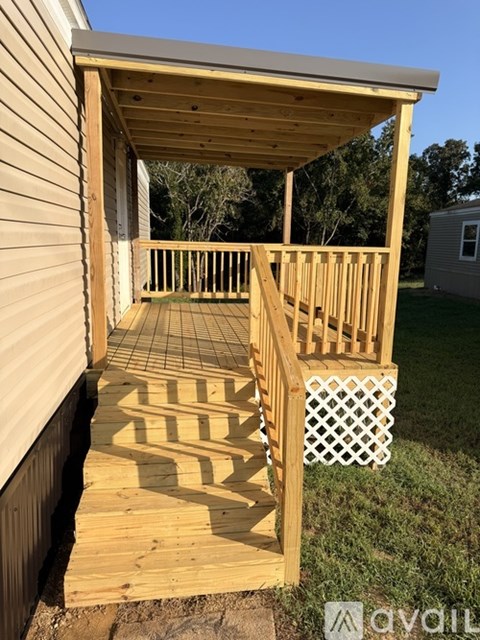 A wooden deck with a lattice design on the railing.