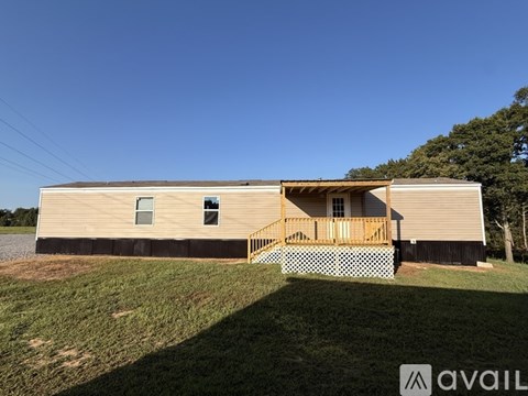 A house with a porch and a covered deck is available for rent.