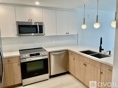 A kitchen with a stainless steel oven and microwave.