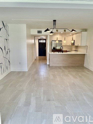 A spacious kitchen with a bar area and a dining table.