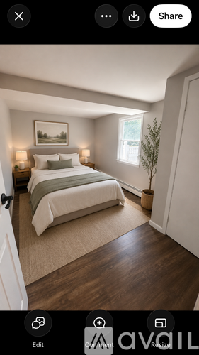 A bedroom with a large bed and a painting on the wall.