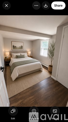 A bedroom with a large bed and a painting on the wall.
