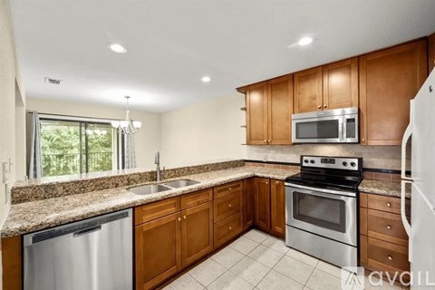 A kitchen with wooden cabinets and stainless steel appliances.