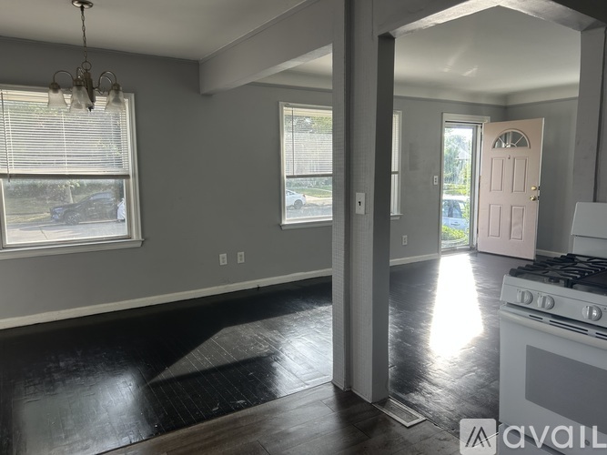 A kitchen with a black floor and a white stove top oven.