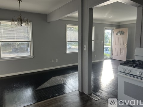 A kitchen with a black floor and a white stove top oven.