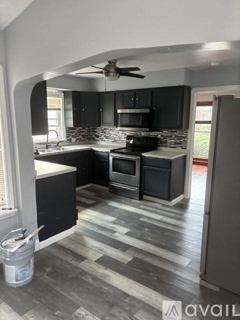 A kitchen with a black and white checkered floor.
