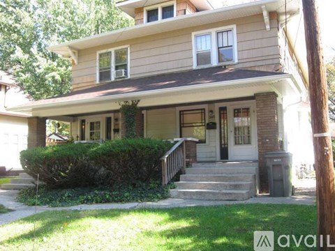 A house with a brown roof and a white door is for sale.