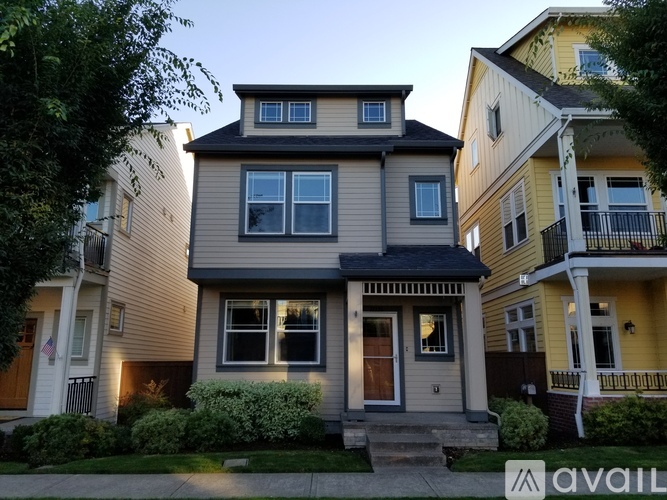 A house with a grey front and a balcony is for sale.