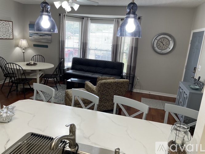 A kitchen with a marble countertop and a sink.