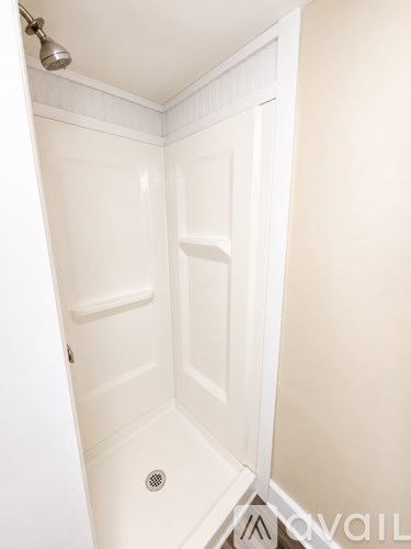 A white bathroom with a shower stall.