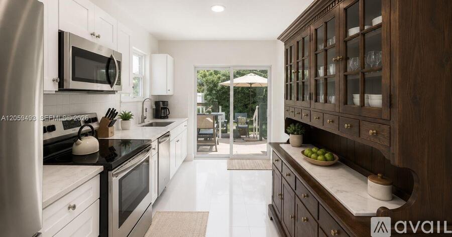 A modern kitchen with dark wood cabinets and white appliances.