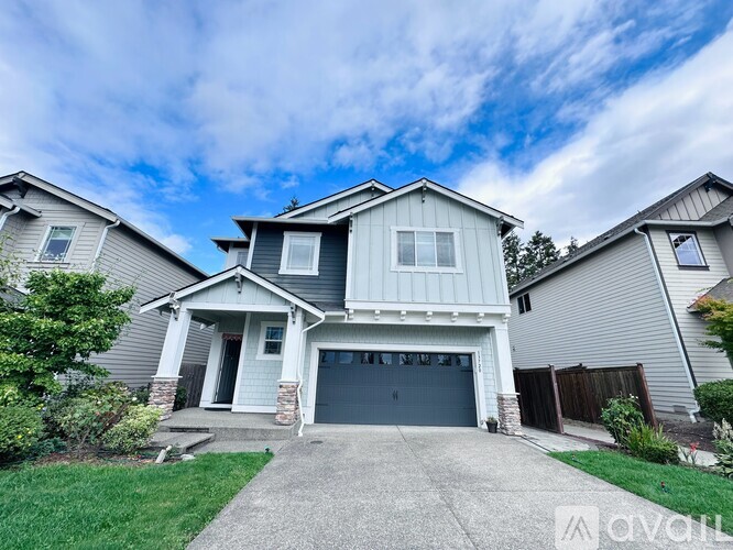 A two-story house with a garage is for sale.