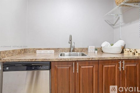 A kitchen with a dishwasher and a sink.
