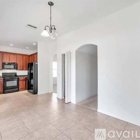 A kitchen with wooden cabinets and black appliances is shown.