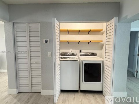 A white kitchen with a white fridge and white oven with a white microwave above it.
