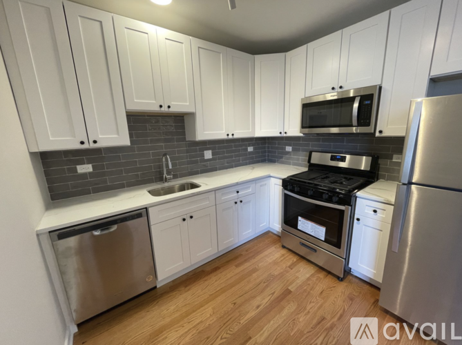 A kitchen with white cabinets and stainless steel appliances.