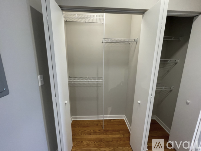 A walk-in closet with a glass door and shelves.