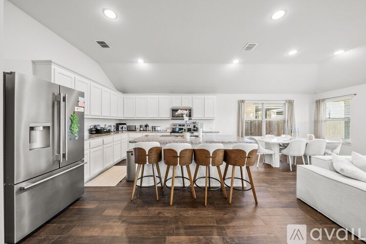 A modern kitchen with a dining table and chairs.