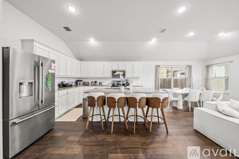 A modern kitchen with a dining table and chairs.