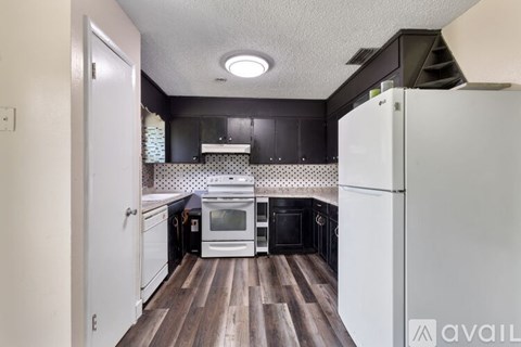 A kitchen with a white refrigerator and a white oven.