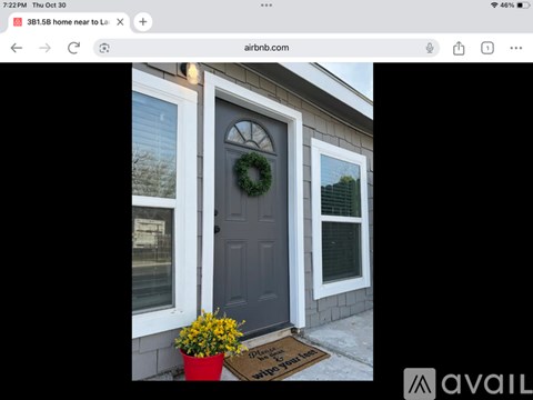A house with a dark grey door and a wreath on it.