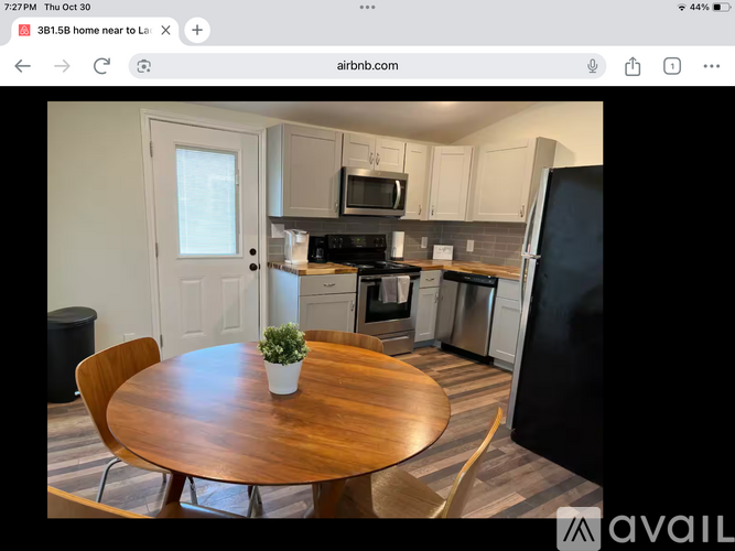 A kitchen with a wooden table and chairs is shown.