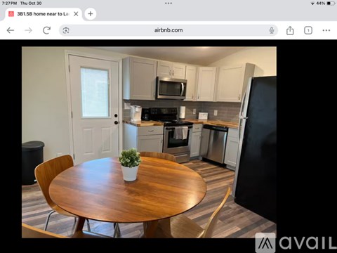 A kitchen with a wooden table and chairs is shown.