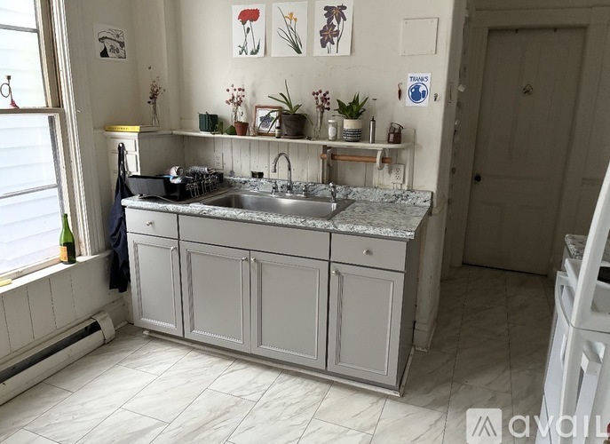 A kitchen with a sink and cabinets.