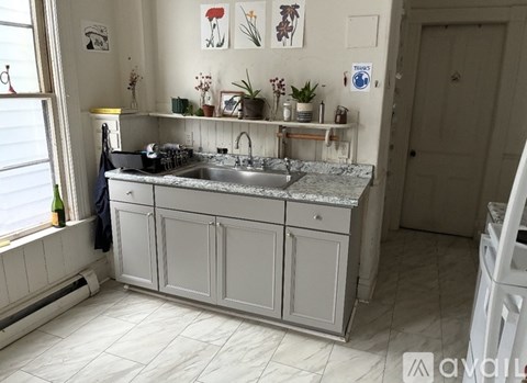 A kitchen with a sink and cabinets.