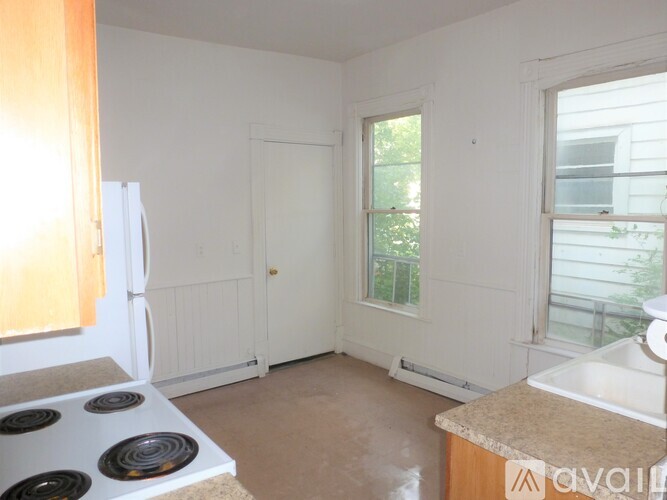 A kitchen with a stove top and a sink.