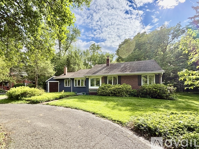 A house with a grey roof and a green lawn.