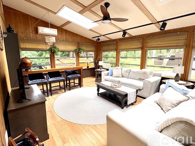 A living room with a white couch and a wooden floor.