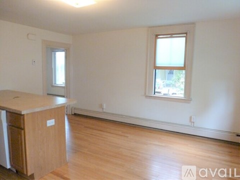 A room with a window and a counter is available for rent.
