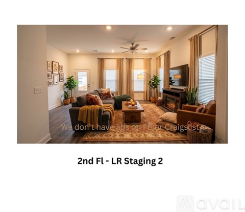 A living room with a sofa set and a rug.