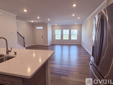 A kitchen with a marble countertop and a refrigerator.