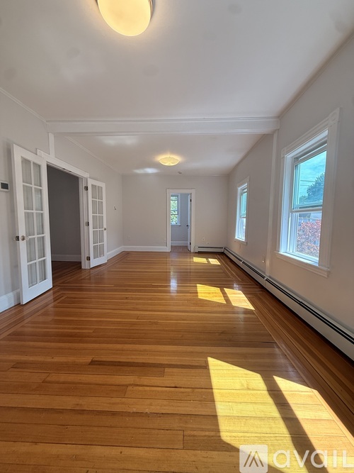 A room with wooden floors and white walls.