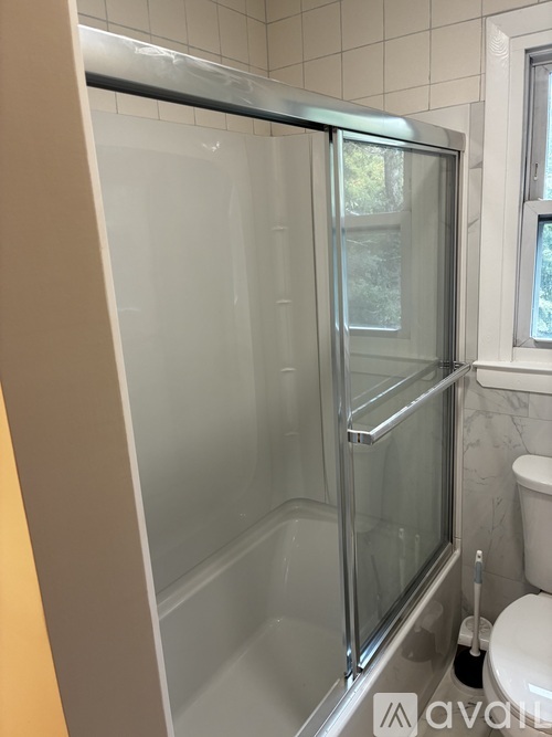 A glass shower stall in a bathroom.