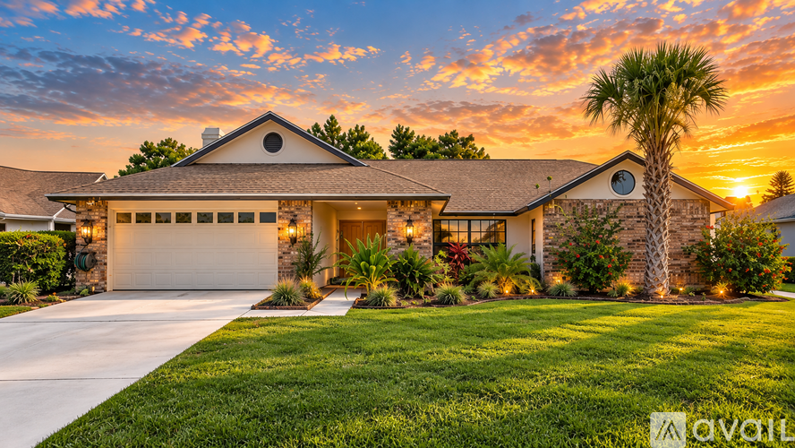 A house with a palm tree in front and a sunset in the background.