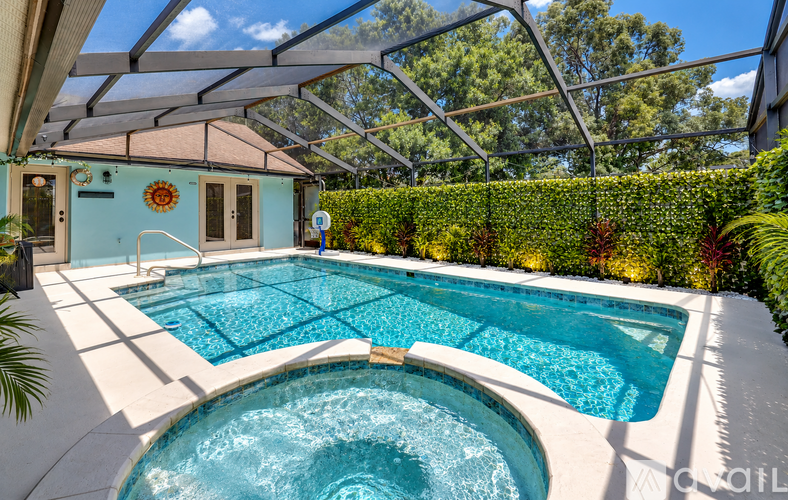 A pool with a hot tub in the middle of it.
