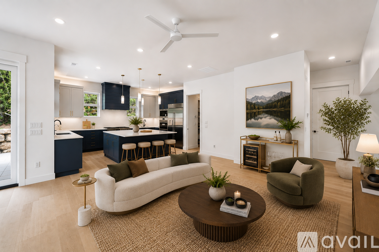 A modern living room with a large white sofa and a coffee table.