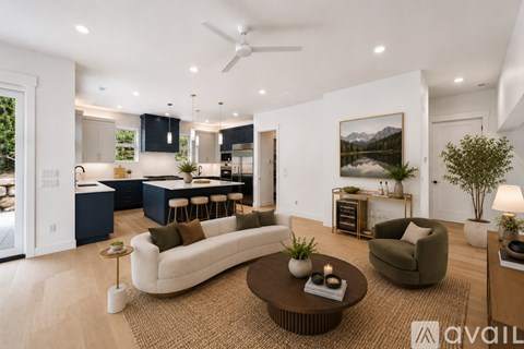 A modern living room with a large white sofa and a coffee table.