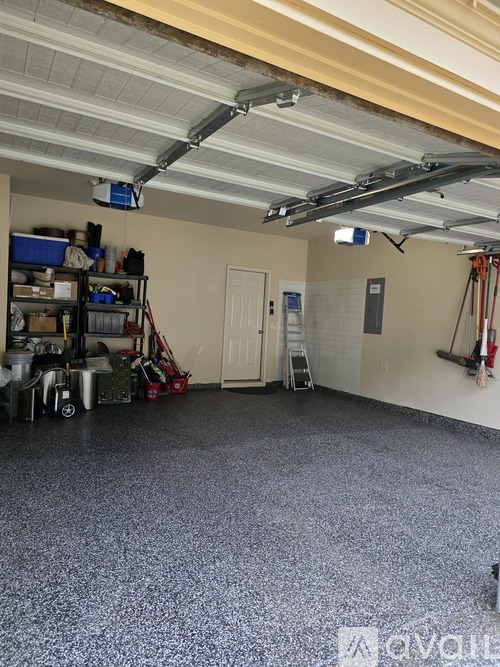 A garage with a grey floor and a white ceiling.