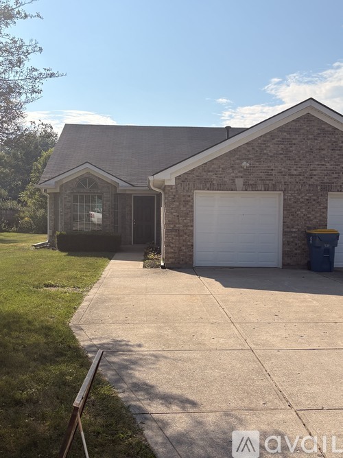 A house with a garage and a driveway.