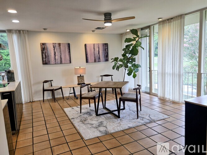 A living room with a table and chairs.