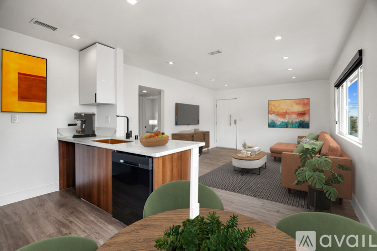 A modern kitchen with a dining table and chairs.