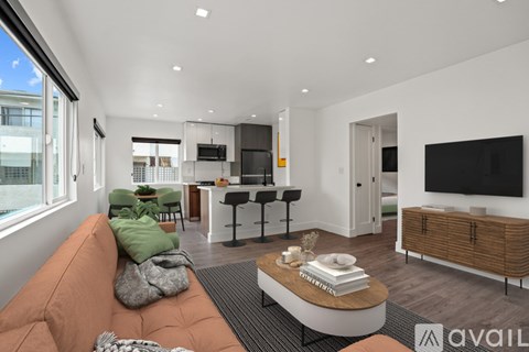 A modern living room with a brown sofa and a television.